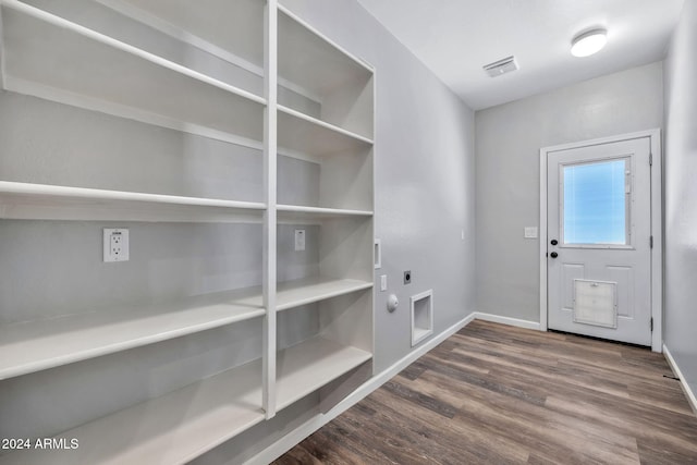 clothes washing area with electric dryer hookup, dark hardwood / wood-style floors, and hookup for a gas dryer