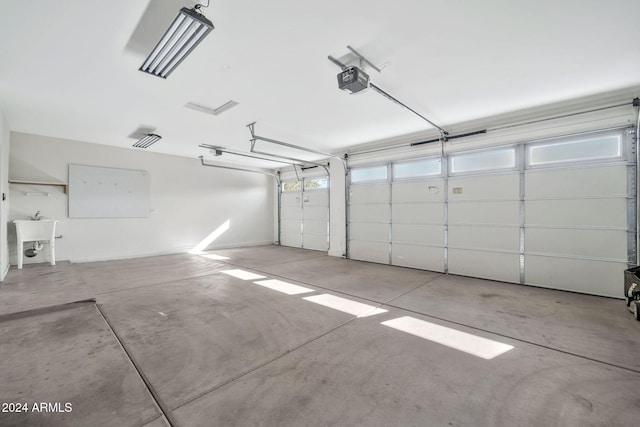 garage with a garage door opener and sink