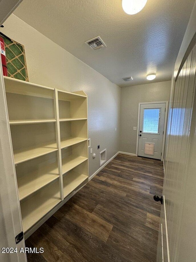 laundry area featuring hookup for a washing machine, dark hardwood / wood-style flooring, and a textured ceiling