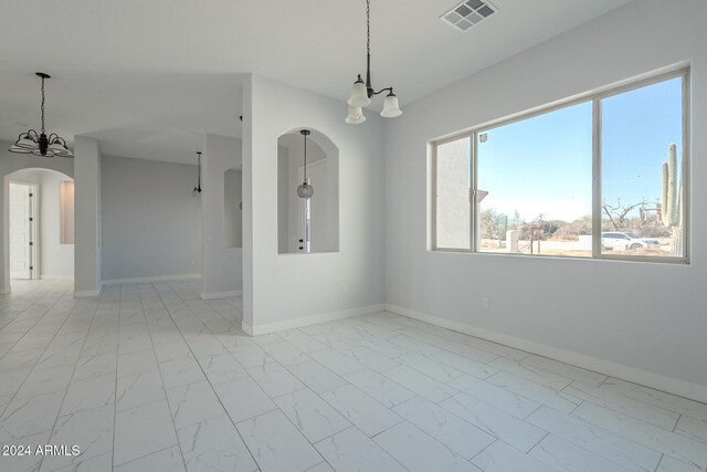 empty room with a notable chandelier