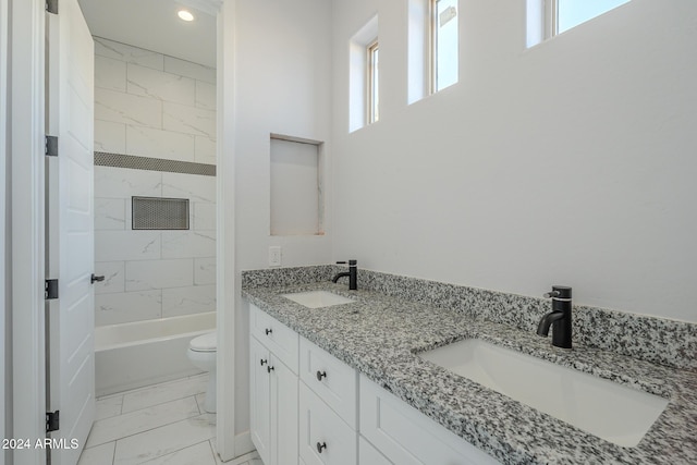 full bathroom with vanity, toilet, plenty of natural light, and tiled shower / bath combo