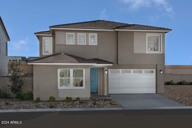 traditional-style home with a tile roof, concrete driveway, a garage, and stucco siding