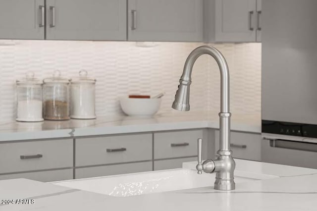 details with light countertops, tasteful backsplash, and gray cabinets
