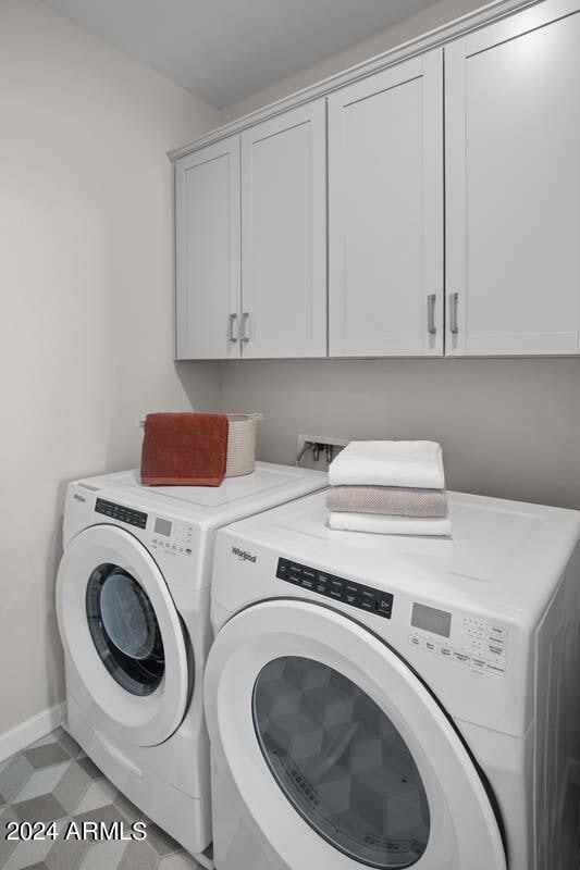 laundry area with cabinets and separate washer and dryer