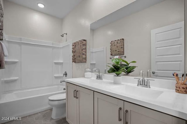 full bathroom featuring double vanity, toilet, shower / bathtub combination, and a sink
