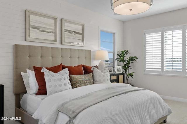 carpeted bedroom featuring baseboards