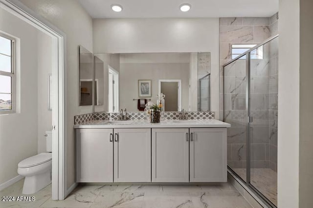 bathroom with toilet, a shower with shower door, and vanity