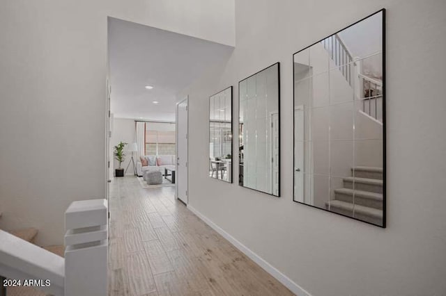 corridor with light hardwood / wood-style flooring