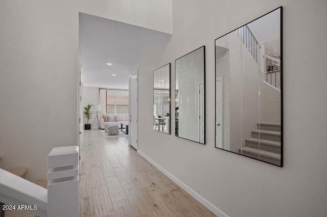 hall with recessed lighting, baseboards, and wood finished floors