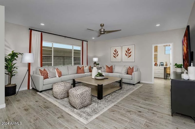 living room with ceiling fan, baseboards, light wood-type flooring, and recessed lighting