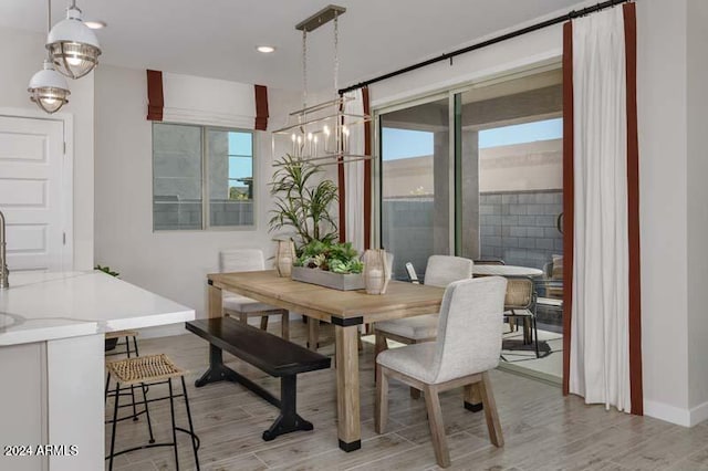 dining room with baseboards, light wood-style flooring, and recessed lighting