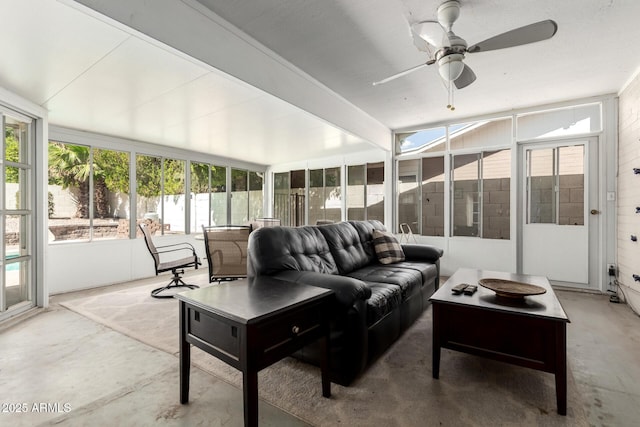 sunroom / solarium featuring an outdoor living space, ceiling fan, and concrete floors