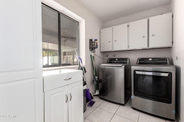 washroom featuring light tile patterned floors, cabinet space, and washer and dryer