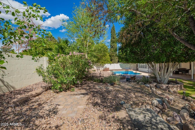 view of yard with a fenced backyard, a fenced in pool, and a patio