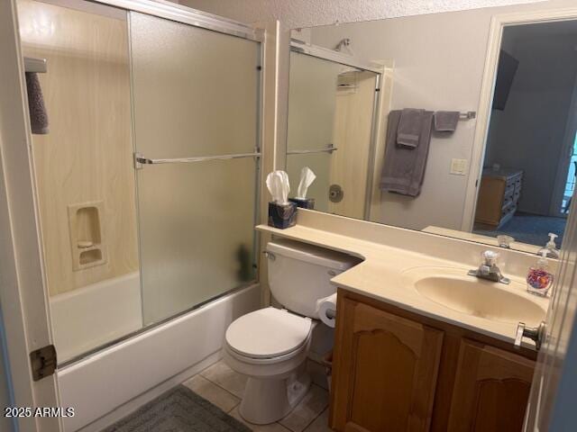 full bathroom featuring toilet, tile patterned flooring, vanity, and enclosed tub / shower combo