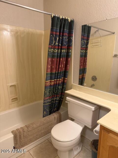 full bathroom with tile patterned floors, toilet, vanity, and shower / tub combo