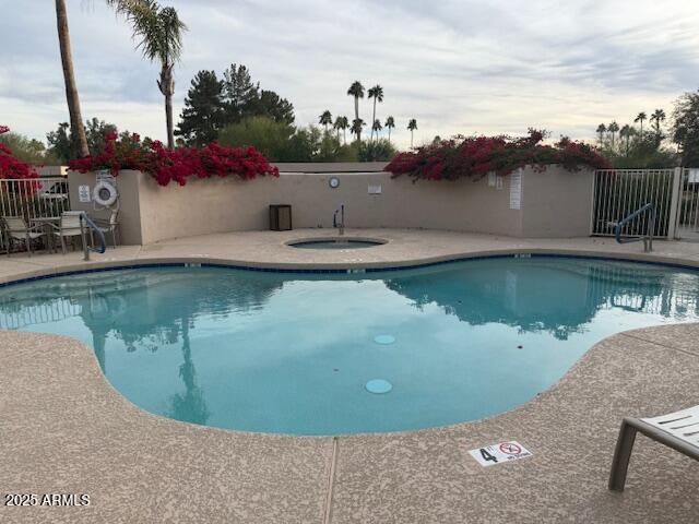 view of pool featuring a patio and a community hot tub