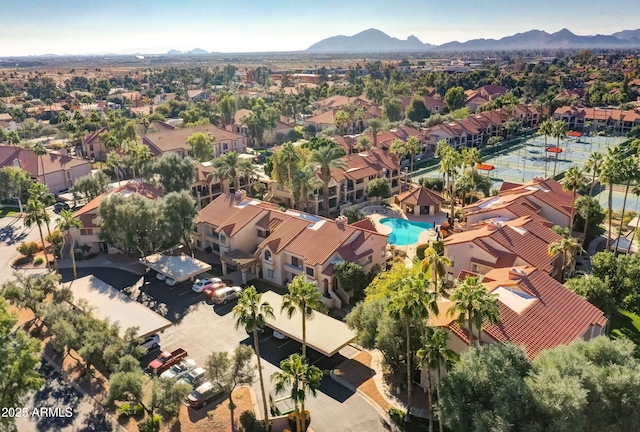 birds eye view of property with a mountain view