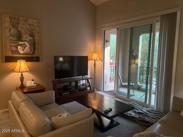 living room with carpet floors and a healthy amount of sunlight