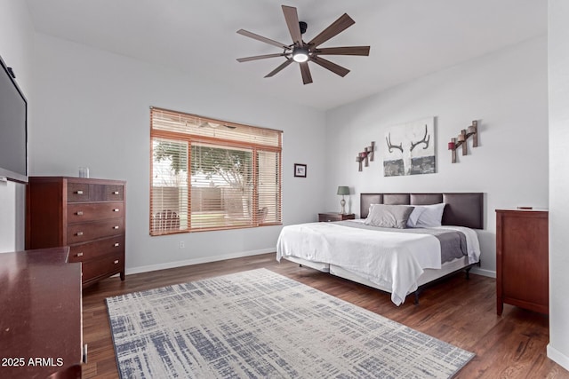 bedroom featuring a ceiling fan, baseboards, and dark wood-style flooring