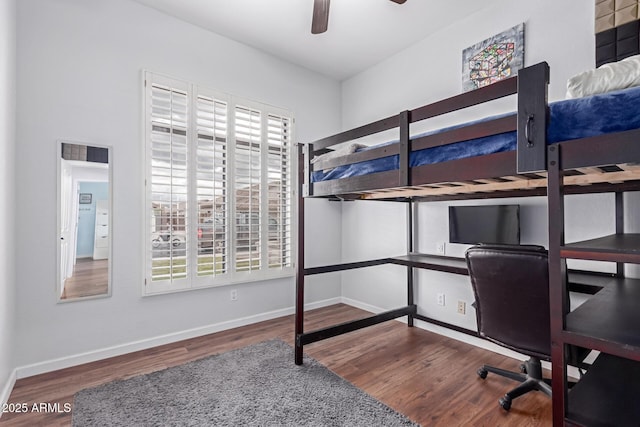 bedroom with baseboards, wood finished floors, and a ceiling fan