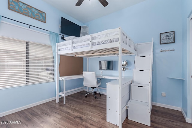 bedroom with ceiling fan, baseboards, and wood finished floors