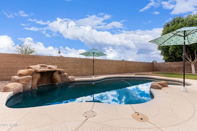 view of swimming pool featuring a patio area, a fenced backyard, and a fenced in pool