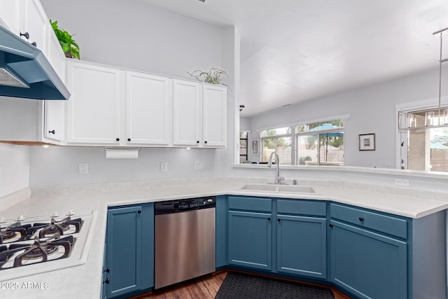 kitchen featuring blue cabinetry, white gas stovetop, under cabinet range hood, dishwasher, and a sink