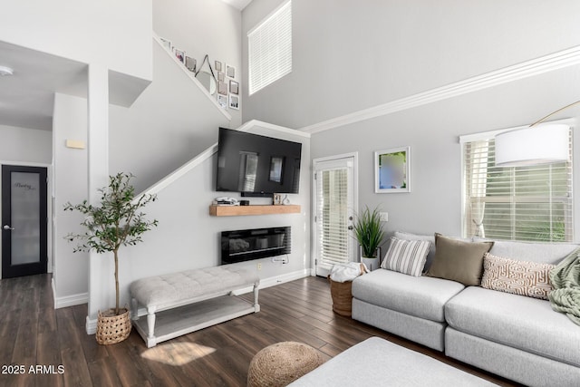 1324 S Banning St, Gilbert, AZ 85296 - living area featuring a towering ceiling, wood finished floors, baseboards, stairway, and a glass covered fireplace