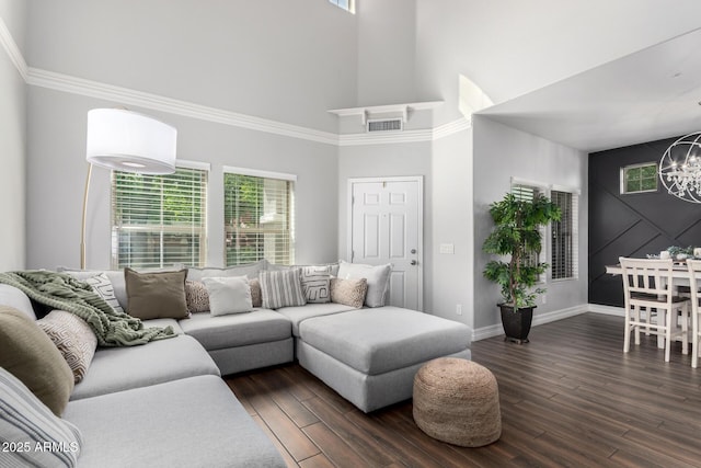 1324 S Banning St, Gilbert, AZ 85296 - living room with a high ceiling, a chandelier, healthy amount of natural light, dark wood-style flooring, and baseboards