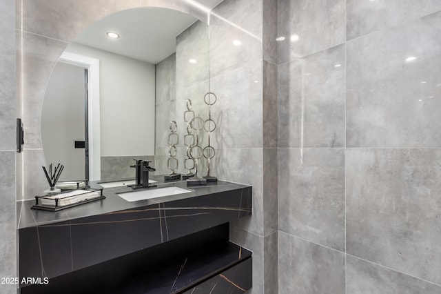 bathroom featuring tile walls and vanity