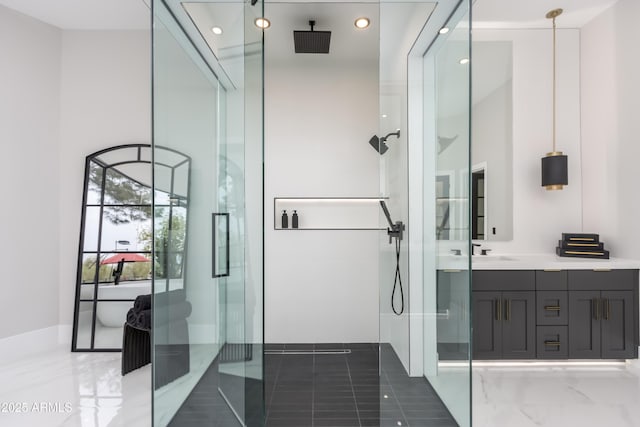 bathroom featuring vanity, a shower with shower door, and recessed lighting