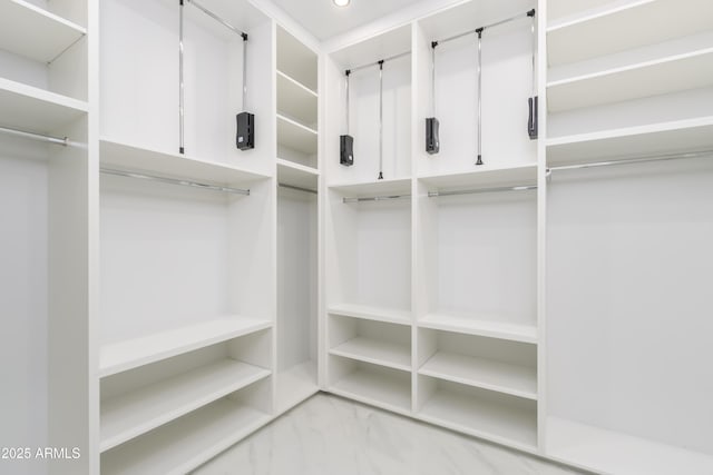 spacious closet with marble finish floor