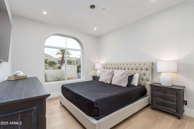 bedroom with baseboards, wood finished floors, and recessed lighting