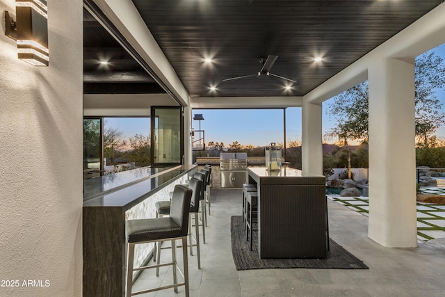 view of patio / terrace featuring outdoor wet bar and an outdoor kitchen