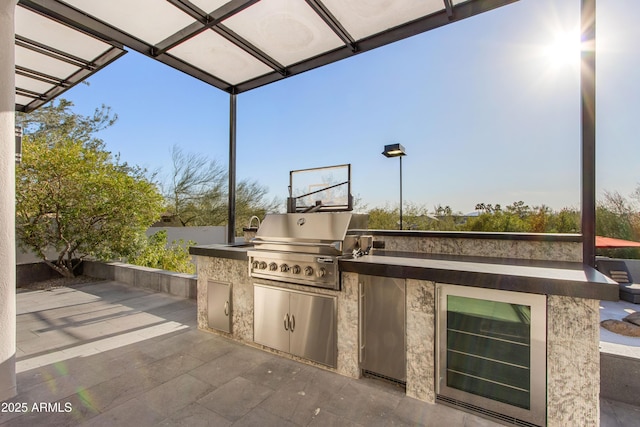 view of patio / terrace featuring exterior kitchen, fence, and area for grilling