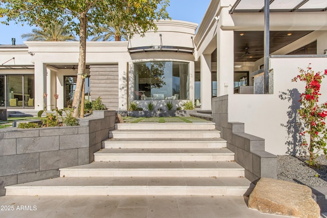 entrance to property with stucco siding