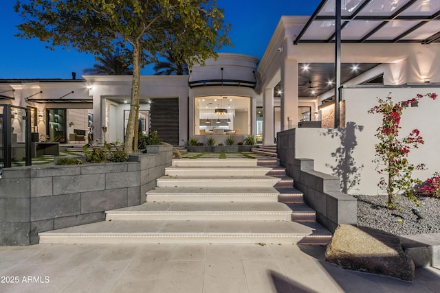 view of exterior entry featuring stucco siding