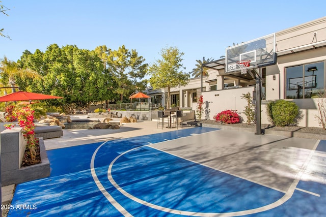 view of sport court featuring community basketball court and fence