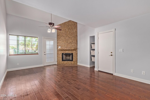 unfurnished living room with ceiling fan, dark hardwood / wood-style floors, high vaulted ceiling, and a fireplace