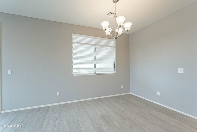 18766 W Montebello Ave, Litchfield Park, AZ 85340 - empty room with visible vents, baseboards, light wood-type flooring, and a chandelier