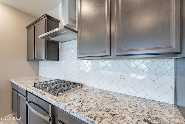 18766 W Montebello Ave, Litchfield Park, AZ 85340 - kitchen featuring tasteful backsplash, appliances with stainless steel finishes, wall chimney range hood, and light stone countertops