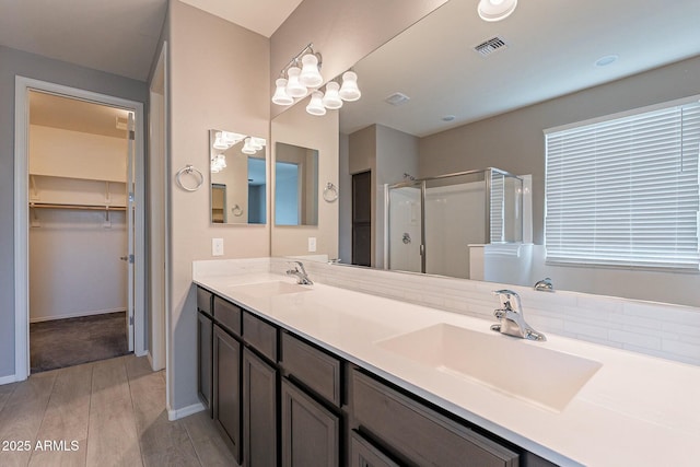 18766 W Montebello Ave, Litchfield Park, AZ 85340 - bathroom with a shower stall, double vanity, a sink, and visible vents