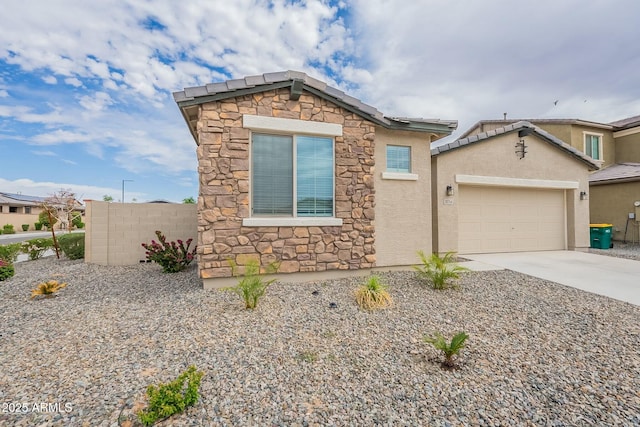 18766 W Montebello Ave, Litchfield Park, AZ 85340 - view of front of property with a tiled roof, an attached garage, stone siding, stucco siding, and driveway