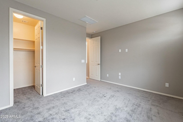 18766 W Montebello Ave, Litchfield Park, AZ 85340 - unfurnished bedroom featuring visible vents, a spacious closet, carpet flooring, and baseboards