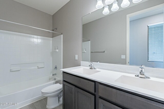 18766 W Montebello Ave, Litchfield Park, AZ 85340 - bathroom featuring shower / bath combination, double vanity, a sink, and toilet