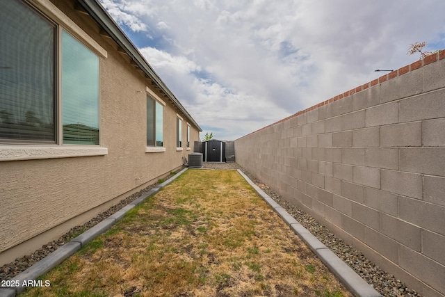 18766 W Montebello Ave, Litchfield Park, AZ 85340 - view of property exterior featuring a yard, central air condition unit, a fenced backyard, and stucco siding