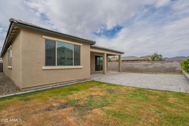 18766 W Montebello Ave, Litchfield Park, AZ 85340 - back of house featuring a yard, fence, a patio, and stucco siding