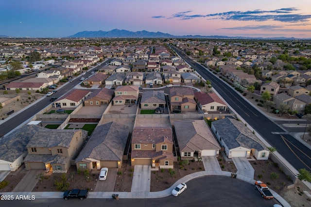 aerial view at dusk of a residential view and a mountain view