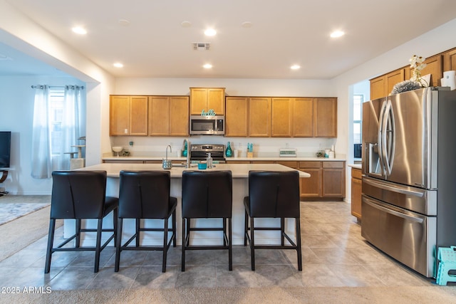 kitchen with stainless steel appliances, healthy amount of natural light, light countertops, and recessed lighting